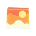 Bomb Cosmetics Here Comes the Sun Soap Slice on a white background with orange, peach and cream layers