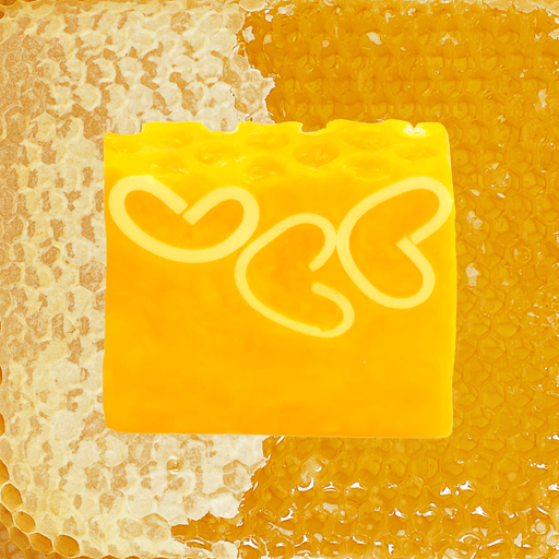 Bomb Cosmetics Honey Bee Good Soap Slice styled on a honeycomb background with heart detail