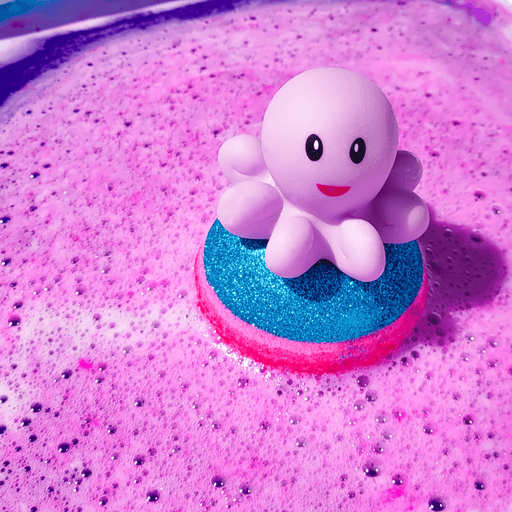 Bomb Cosmetics Octopus’s Garden Bath Blaster fizzing in the bath creating pink water with an octopus topper