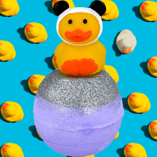 Bomb Cosmetics Quack Fu Panda Bath Blaster with panda duck topper on a blue background with rubber ducks
