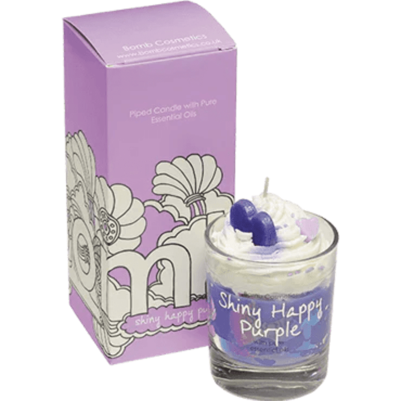 Bomb Cosmetics Shiny Happy Purple piped scented candle—white whipped wax with purple heart toppers beside matching lilac gift box.