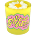 Bomb Cosmetics Stay Golden flower candle—yellow jar with white wax daisy bloom, papaya-mango-guava tropical scent.