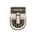 Close up of Book Club enamel metal bookmark with bookshop storefront design