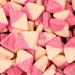 Close-up of Bubs Sour Diamond Strawberry Vanilla sour diamond sweets in pink and white