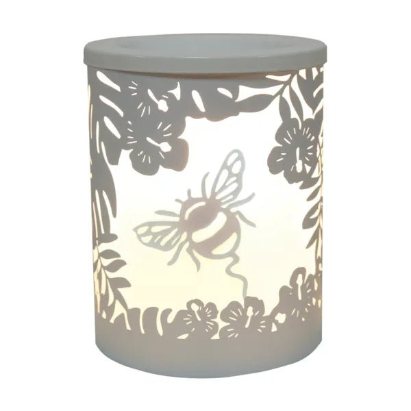 White bumblebee silhouette electric wax melt burner glowing warmly with floral and leaf cut-out detailing.