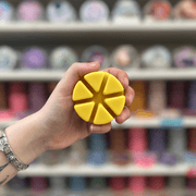 Buttery Croissant cream segmented wax melt held in hand