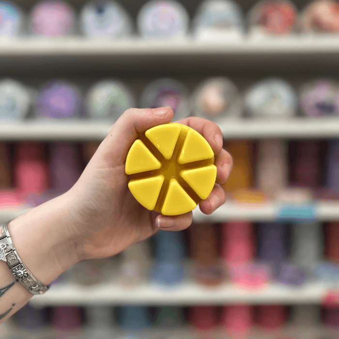 Buttery Croissant cream segmented wax melt held in hand