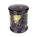 Angled view of Candlelight Blackberry & Fig Tree large glass lidded jar candle in rich purple glass with blackberry design.