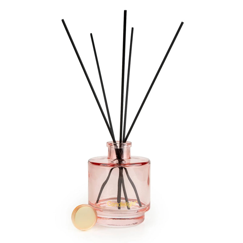 Candlelight Cherry Blossom & Sakura reed diffuser in blush pink glass bottle with black reeds on a white background.