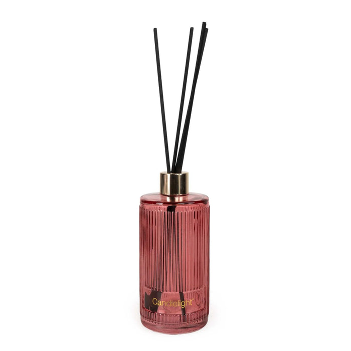 Candlelight Mango & Honey reed diffuser in ribbed pink glass bottle with black reeds and gold collar on a white background.