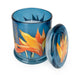 Candlelight Paradise Flower & Mango jar candle shown open with lid beside, blue glass with tropical flower print and white wax.