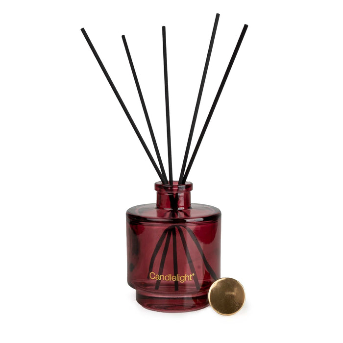 Candlelight Peony & Water Lily reed diffuser set showing boxed packaging, burgundy bottle, black reeds and gold cap.