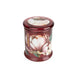 Angled view of Candlelight Peony & Water Lily large glass lidded jar candle in rich red glass with peony artwork.