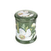 Angled view of Candlelight White Poppy & Sage large glass lidded jar candle in deep green glass with white poppy and leaf print.