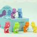 Care Bears mini figures posed around the blind box packaging and display card