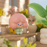 Cell RiCO’s Relax Time tiny green RiCO beside leafy plant pot

