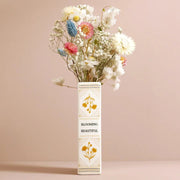 Side view of Little Book of Flowers ceramic vase showing book-shaped design