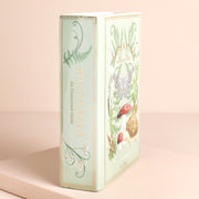 Side view of green ceramic book vase showing book-shaped design