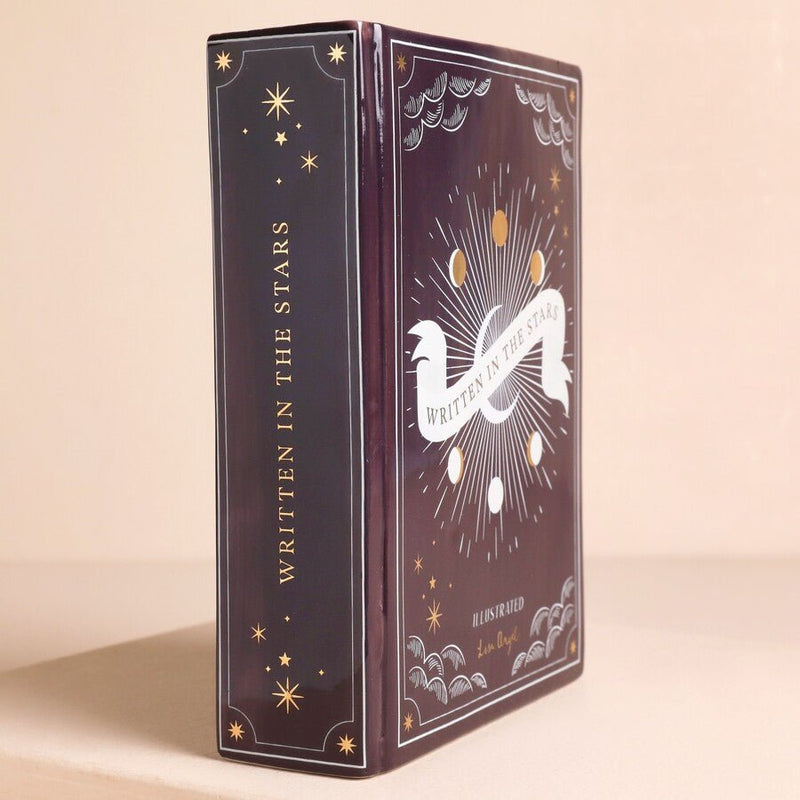 Side view of purple ceramic book vase showing book-shaped design