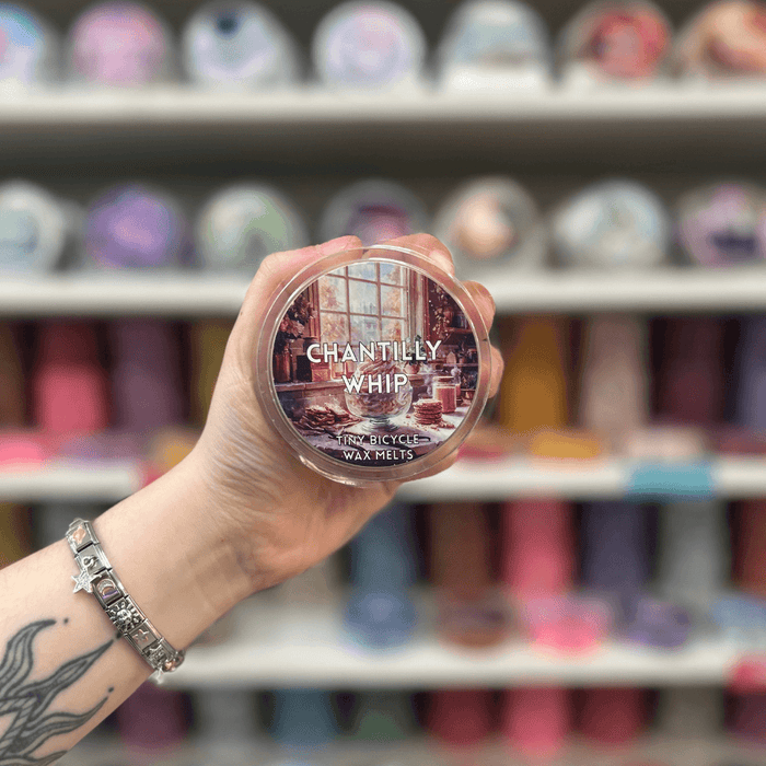 Chantilly Whip wax melt pot with illustrated label, held in hand