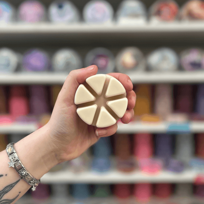 Chantilly Whip cream-coloured segmented wax melt held in hand