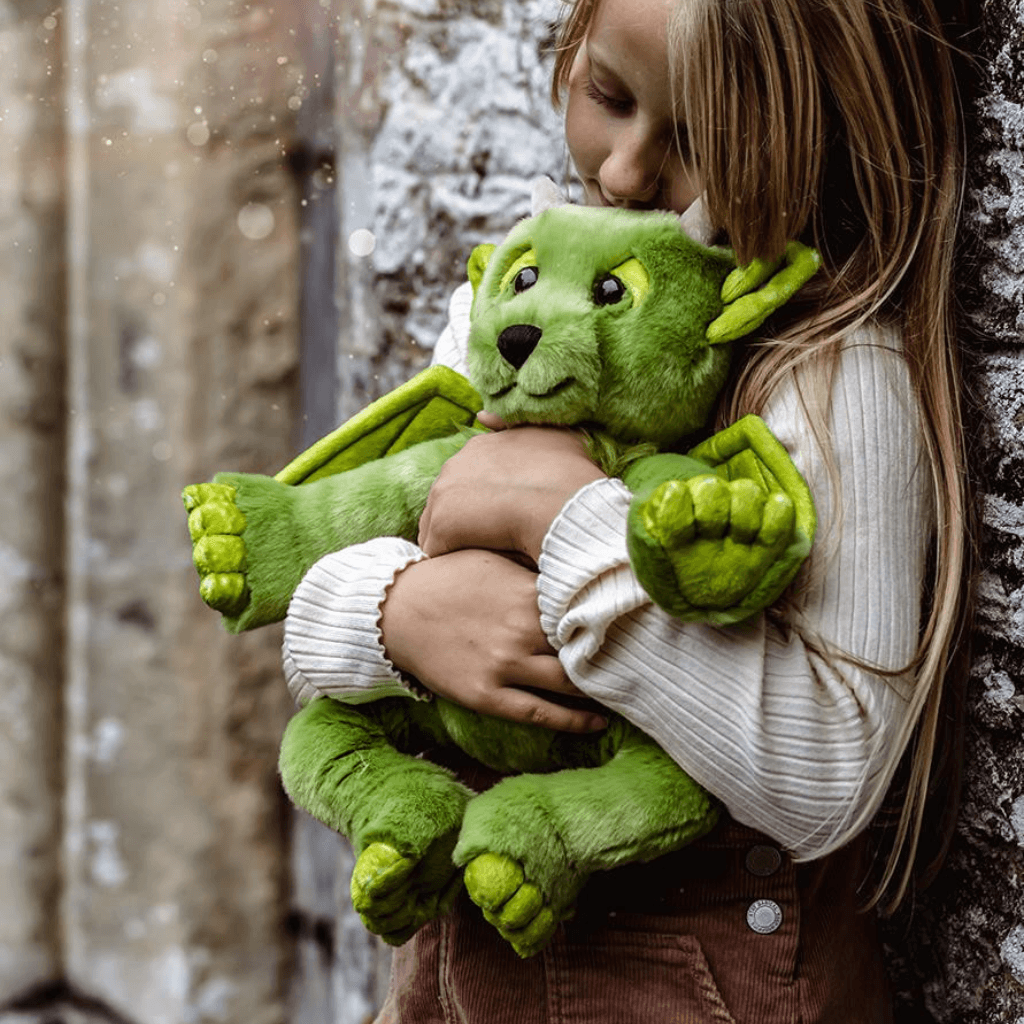 Charlie Bears Bearhouse Spires green plush dragon being cuddled outdoors
