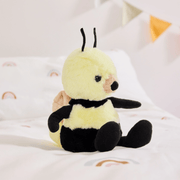 Charlie Bears Bumble Bee yellow plush soft toy sitting on a bed