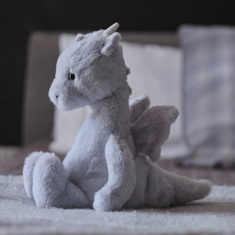 Charlie Bears Draco Dragon cloudy grey plush displayed in a bedroom
