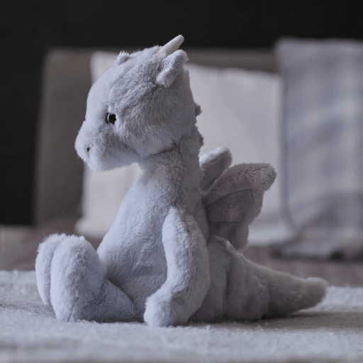 Charlie Bears Draco Dragon cloudy grey plush displayed in a bedroom