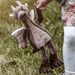 Clubs brown dragon plush from Bearhouse by Charlie Bears 2025, held outdoors, showing wings, horns and long legs