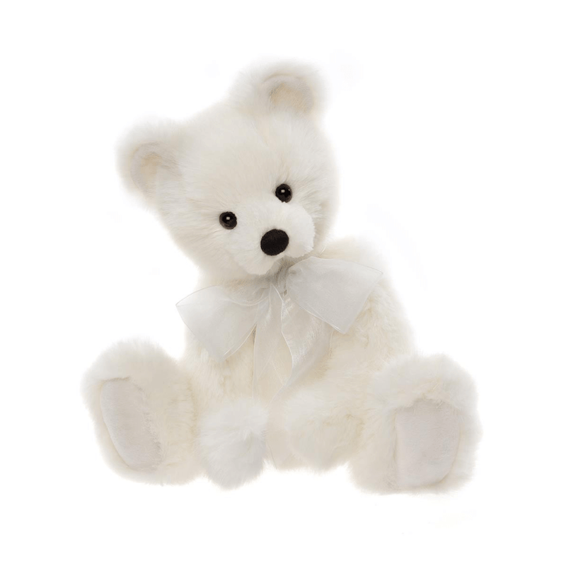 Charlie Bears Little Bean plush teddy bear in soft white fur with white organza bow, angled sitting pose