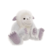 Angled view of Charlie Bears Trundle yeti plush showing his fluffy white fur, gentle expression and lavender paw details