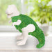 Dinosaur-shaped Chia-Saurus Rex planter sprouting green chia on a windowsill