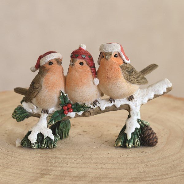 Christmas robin log ornament displayed on a tabletop

