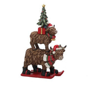 Stacked Highland cow Christmas ornament on red skis, 25cm


