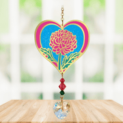 Heart-shaped Chrysanthemum Crystal Suncatcher featuring vivid pink petals and a faceted heart prism scattering rainbows in a sunny window

