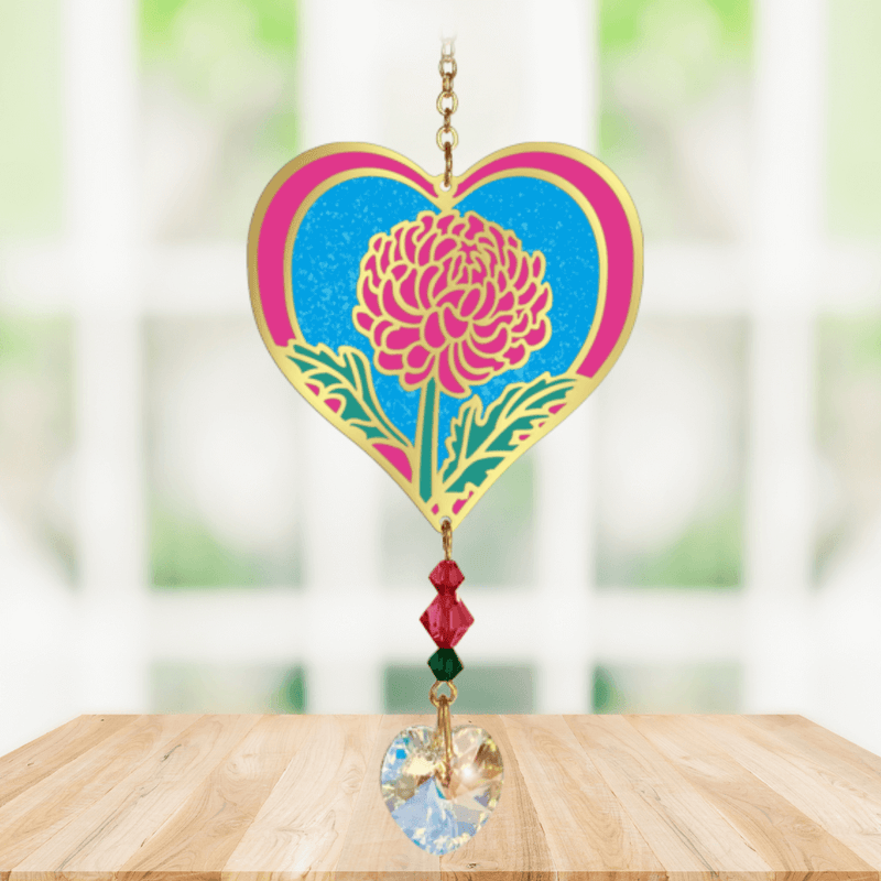 Heart-shaped Chrysanthemum Crystal Suncatcher featuring vivid pink petals and a faceted heart prism scattering rainbows in a sunny window

