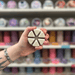 Cinnamon Buns wax melt segments held in hand with colourful wax melt display in the background