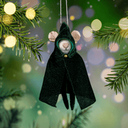 Cloaked mouse felt decoration hanging from a Christmas tree