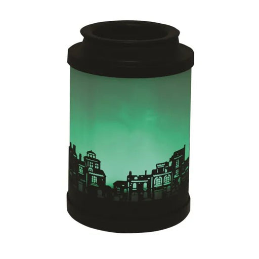 Cloudy Melter Roof Tops wax melt burner lit with green glow and town silhouette


