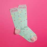 Overlapped mint women’s crew socks with pink accents, cloud and star print, cheeky Come Back With A Warrant text at cuff.