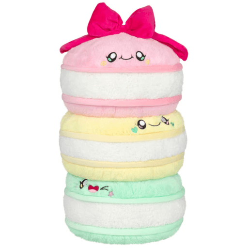 Front view of the Comfort Food Macarons plush toy with embroidered faces and pink bow