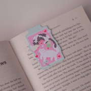 Cosy Cats magnetic bookmark clipped over the page of an open book