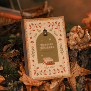 Cosy Season Reading Journal displayed outdoors with autumn foliage