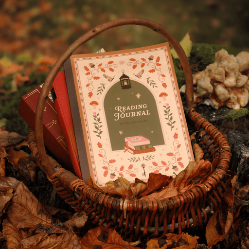 Cosy Season Reading Journal styled in a basket with autumn leaves