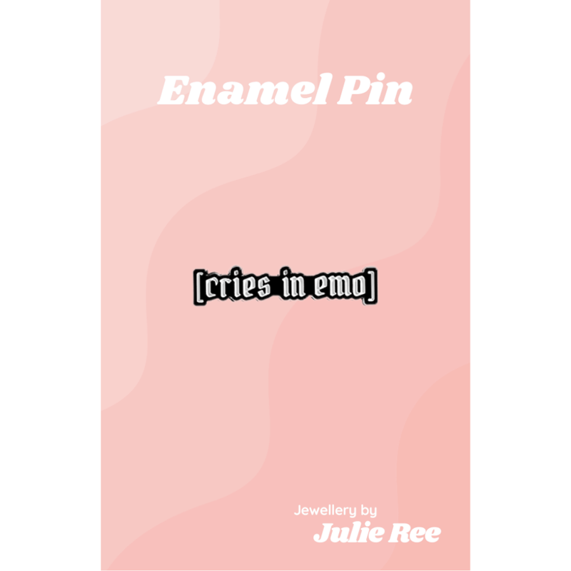 Black and white enamel pin with the text [cries in emo]