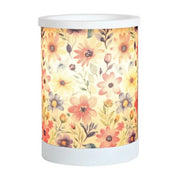 Daisy floral electric wax melt burner switched on, glowing warmly through the floral patterned wrap.