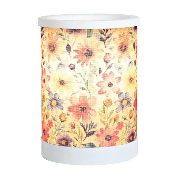 Daisy floral electric wax melt burner switched on, glowing warmly through the floral patterned wrap.