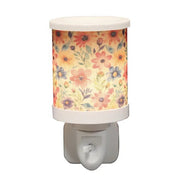 Daisy floral plug in wax melt burner switched on, glowing warmly through the floral design.