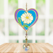 Heart-shaped Daisy Crystal Suncatcher with white daisy motif and faceted rainbow-making heart prism hanging in a sunny window

